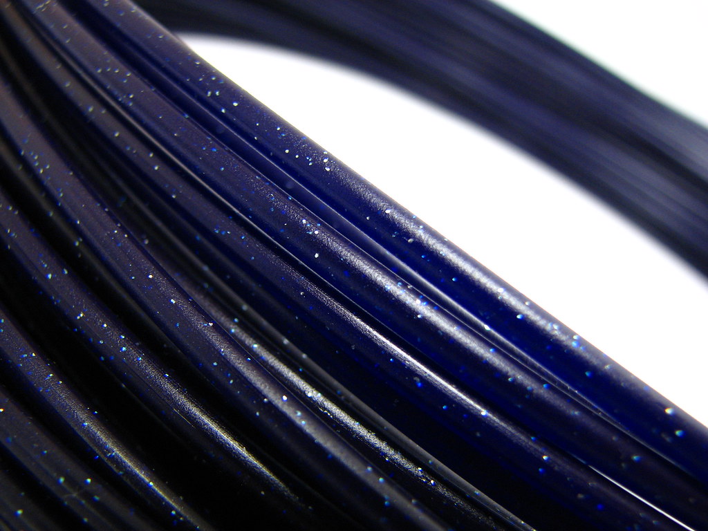Close-up of dark blue cables flecked with points of light